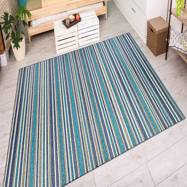 A Couristan Cape Brockton area rug with blue and white stripes on the floor in a kitchen.
