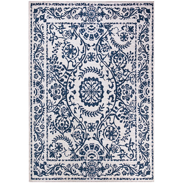 A cream rug with a blue floral medallion design.