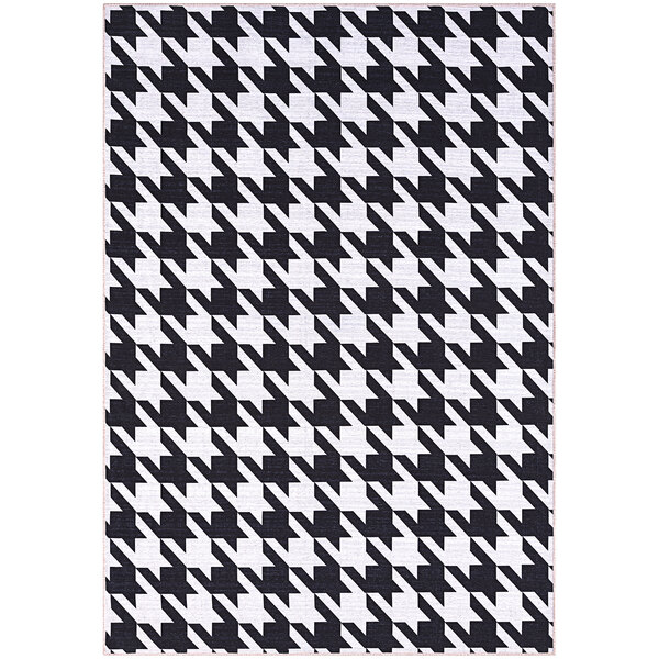 An Abani Parker Collection cream rug with a black and white houndstooth pattern and white border.
