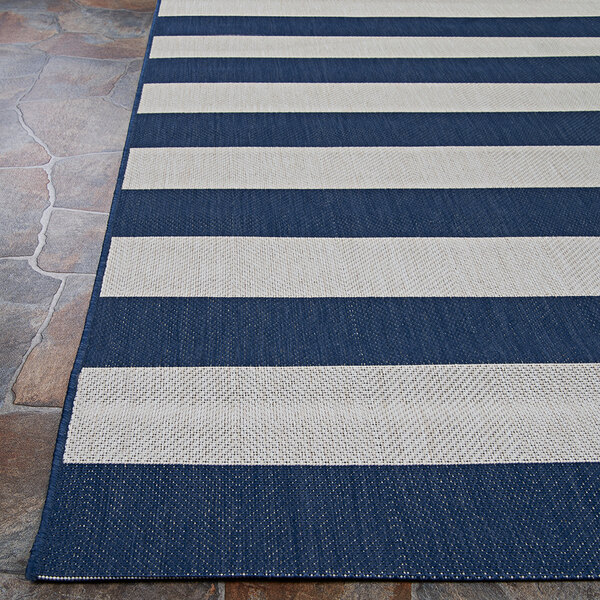 A Couristan Afuera Yacht Club area rug with blue and white stripes.