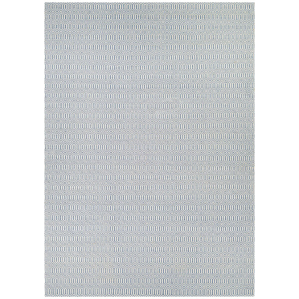 A close-up of a Couristan Southport area rug with light blue dots in a white room.