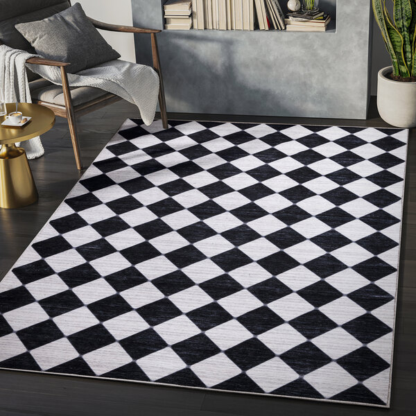 An Abani Parker Collection cream and black area rug with a diamond pattern in a room.