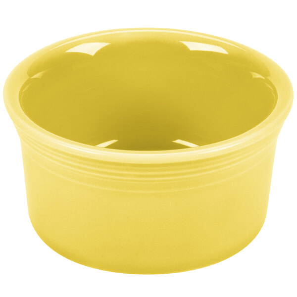 A yellow Fiesta ramekin with a white edge on a white surface.