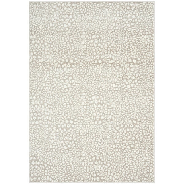 A cream and beige area rug with a cheetah print pattern.