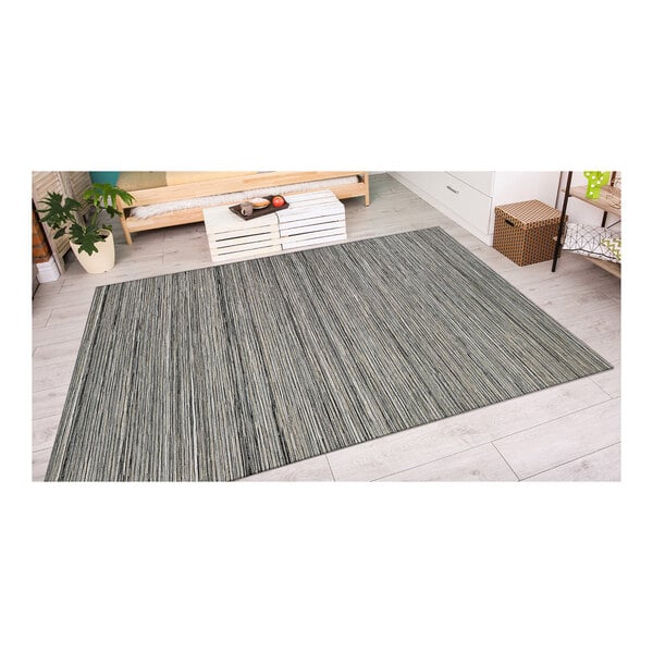 A Couristan light brown and gray area rug with a white pattern on the floor.