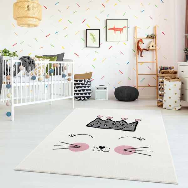 A white baby's room with an Abani pink and cream kitten rug.