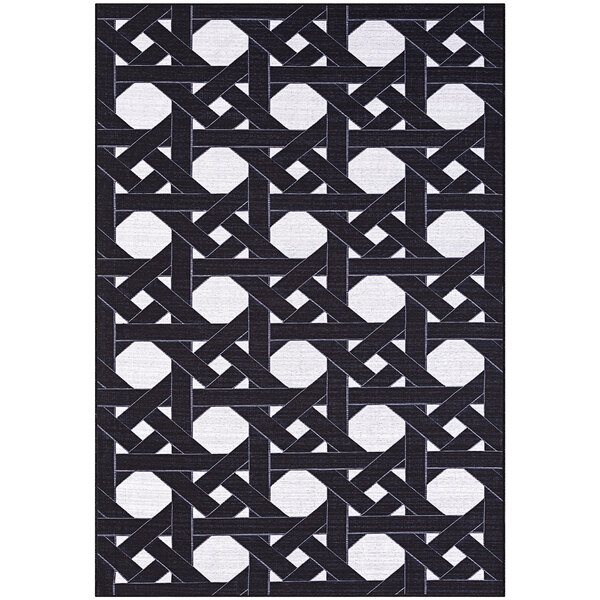An Abani Parker Collection cream and black geometric houndstooth area rug.