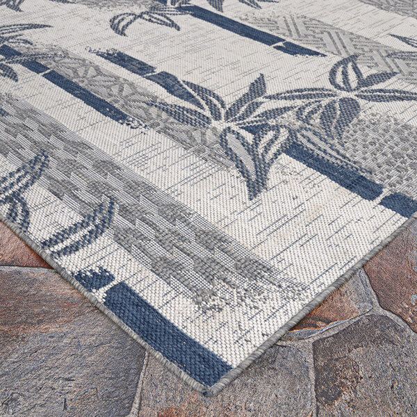 A close-up of a Couristan Everhome bamboo stripe ivory and blue area rug.