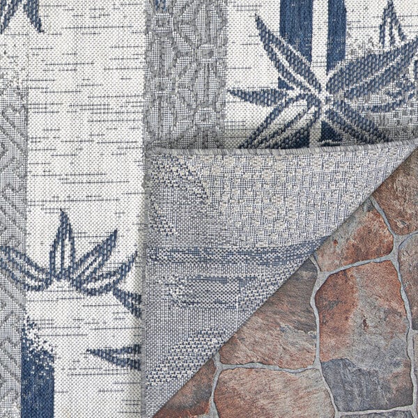 A close up of a Couristan Ivory and Cape Blue Bamboo Stripe area rug with a blue and white pattern.