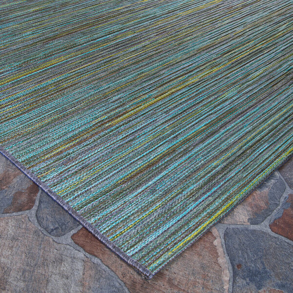 A close-up of a Couristan Cape Hinsdale teal and cobalt area rug with a green and blue stripe pattern.