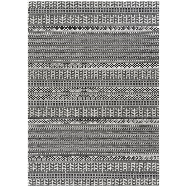 A grey and black woven rug with a geometric pattern.