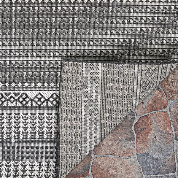 A close up of a Couristan Bristol area rug with a pattern in charcoal and ivory.