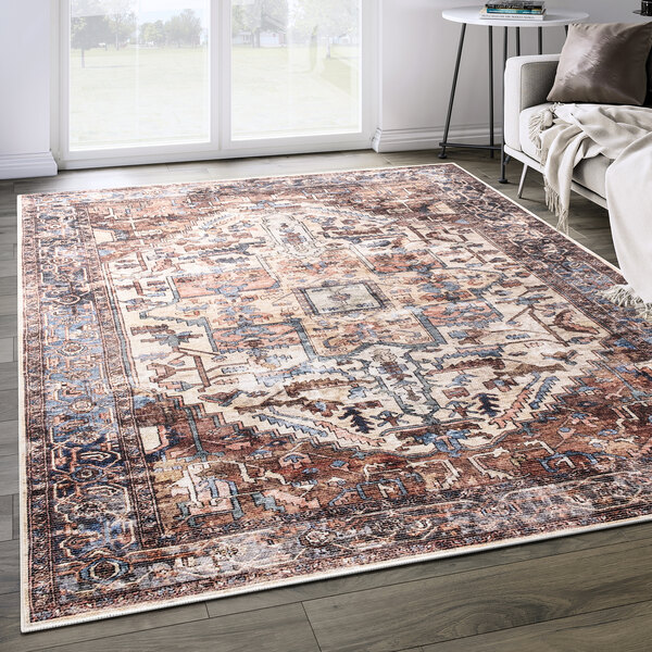 An Abani Lola Collection terracotta area rug with a vintage classic medallion design on a floor.