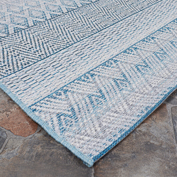 A close-up of a blue and white Couristan Cape Gables Surf Area Rug.