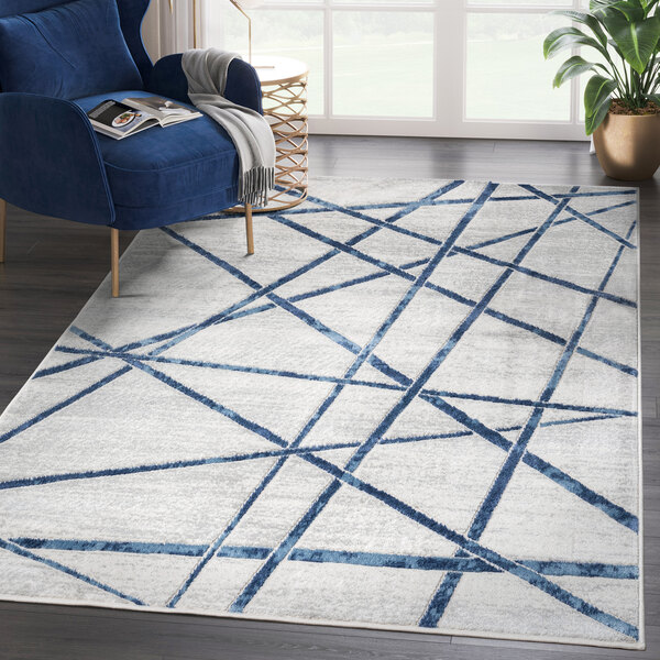 An Abani Atlas Collection blue and gray area rug with criss cross lines in a room.