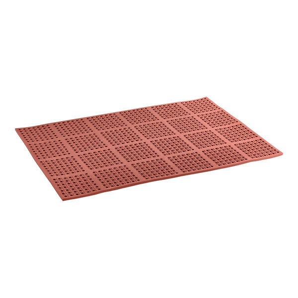 A red rubber rectangular mat with holes.