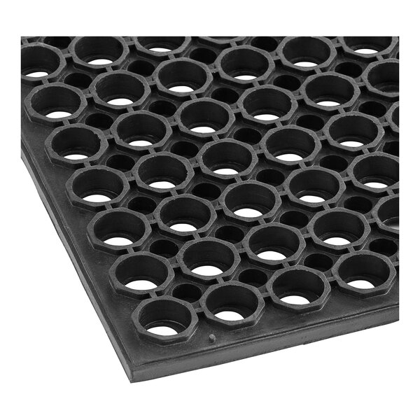 A close up of a black rubber Lavex anti-fatigue floor mat with holes in it.