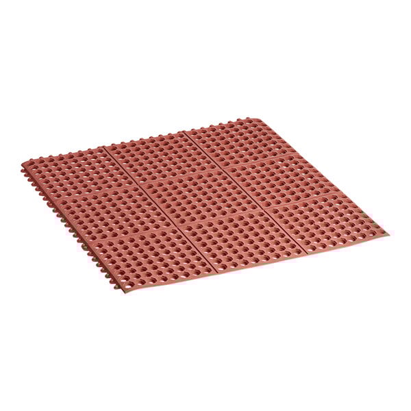 A close-up of a red rubber Lavex anti-fatigue floor mat with holes.