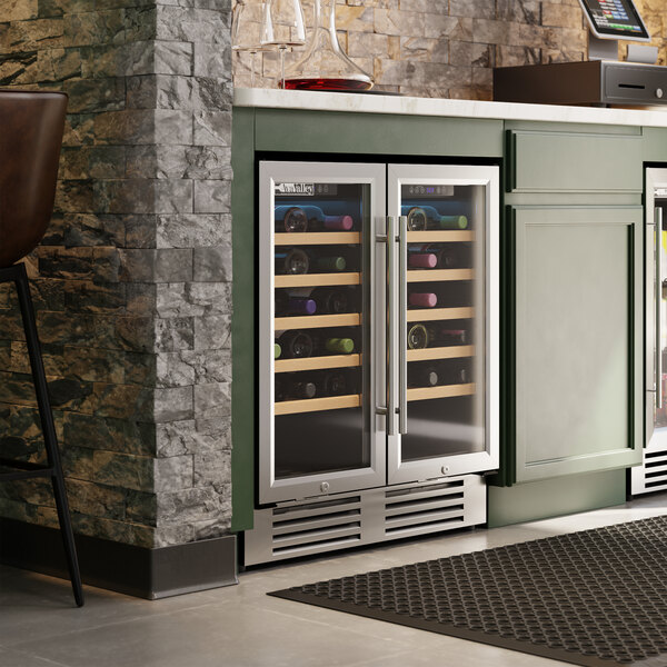 A dual-section, dual-temperature commercial wine cooler with full glass doors and stainless steel trim, built into a kitchen counter.