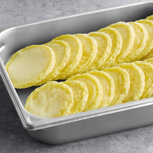 A tray of Papetti's fully cooked scrambled egg patties on a counter.