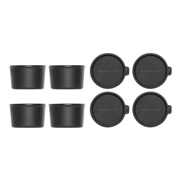 A set of four black plastic KitchenAid ice molds with round lids.