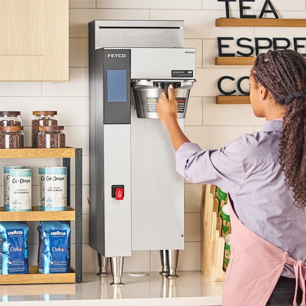 A commercial Fetco CBS-2251 NG Series single automatic digital coffee brewer with a metal brew basket.