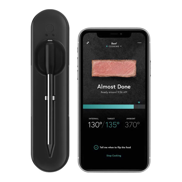 A black and silver Yummly wireless meat thermometer displaying the meat temperature on a smartphone.