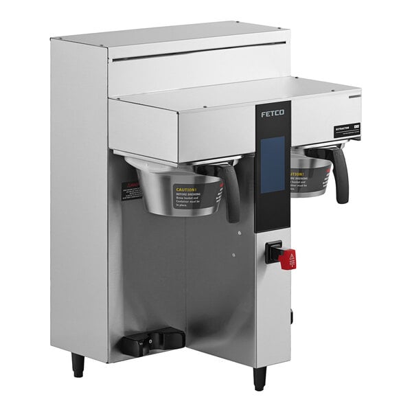 A Fetco commercial coffee brewer with two metal brew baskets on top.