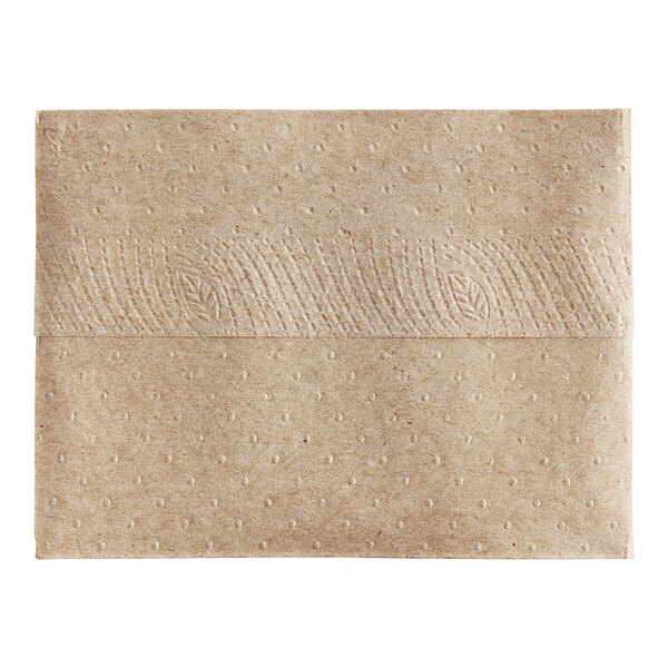 A Tork natural kraft interfold dispenser napkin with a small hole in it.