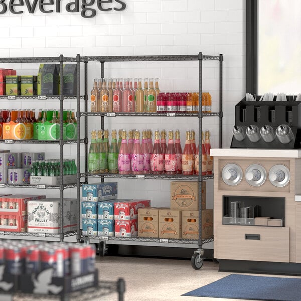 A black epoxy mobile shelf kit with 4 shelves holding beverages in a convenience store.