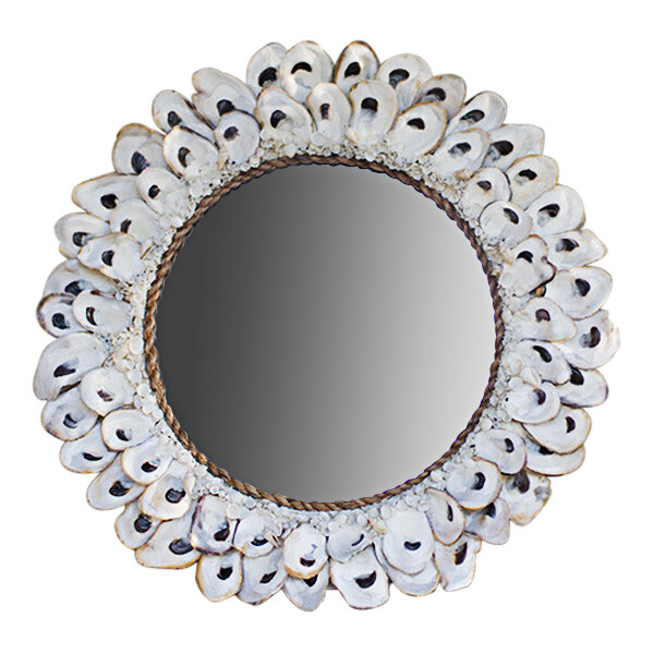 A round mirror with a circular frame made of oyster shells.