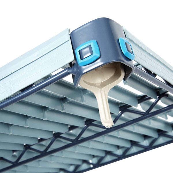 A MetroMax Q shelf with a blue handle on a metal structure.