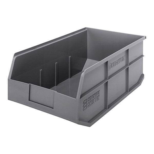 A Quantum gray plastic stackable shelf bin with two compartments.