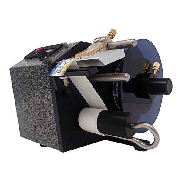 A black and silver Tach-It automatic label dispenser with a label on it.