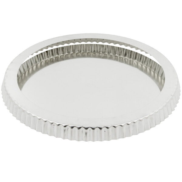 A silver round metal tray with a circular design and removable bottom.