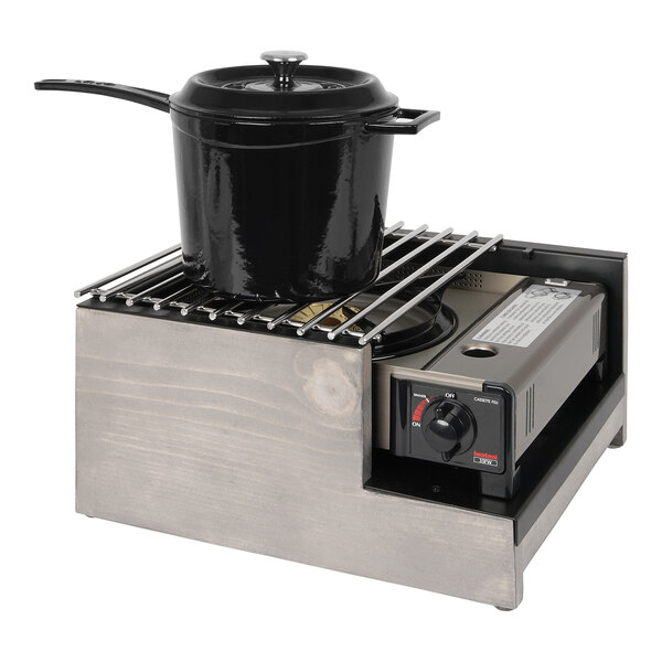 A pot on a gray-washed pine wood Cal-Mil burner frame on a counter.