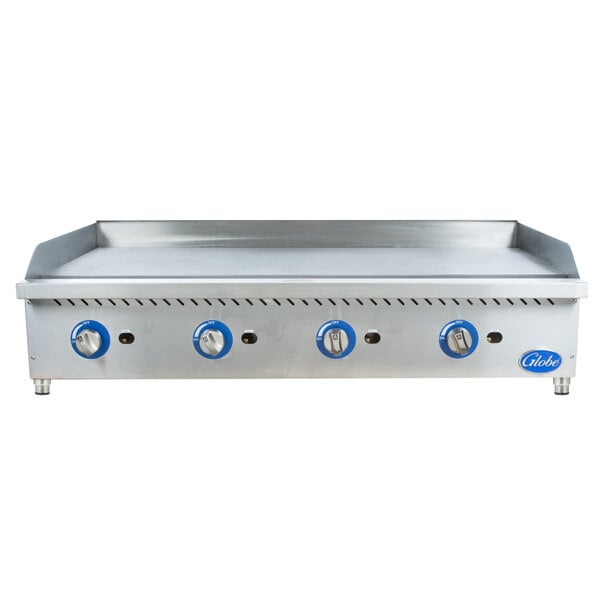 A Globe stainless steel countertop gas griddle with blue knobs on a large rectangular metal surface.