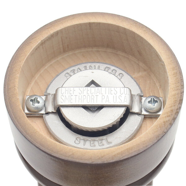 A Chef Specialties walnut pepper mill with a metal handle and lid.