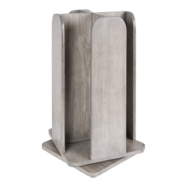 A gray-washed pine wood Cal-Mil countertop organizer with 4 sections on a table.