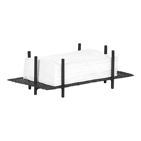 A stack of white napkins in a black metal Cal-Mil napkin holder.