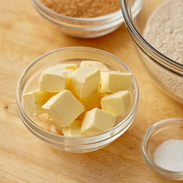 cubes of unsalted butter in a bowl next to flour