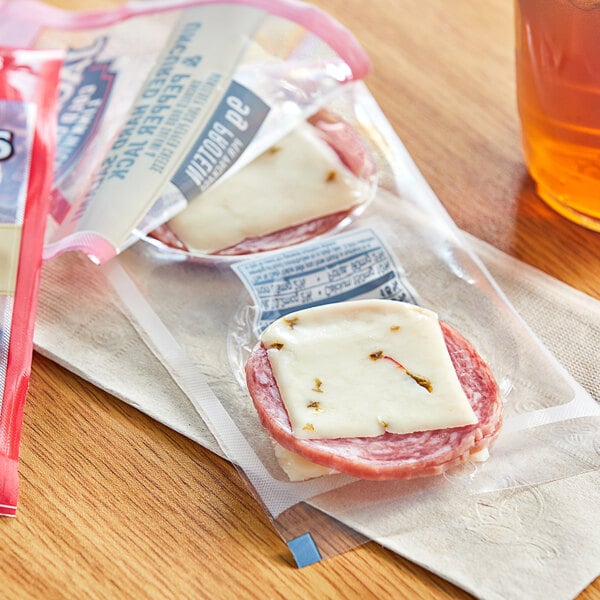 A package of Jack Link's hard salami and pepper jack cheese on a table.