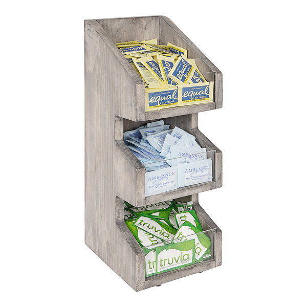 A Cal-Mil wooden condiment organizer with three boxes on a shelf.