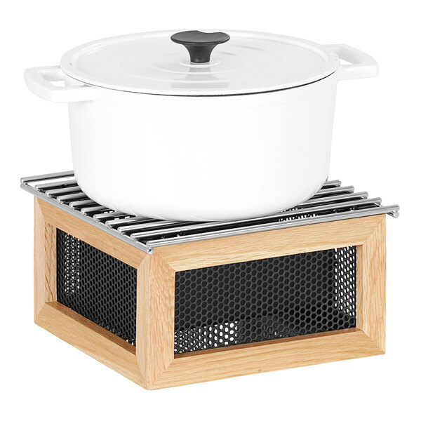 A white pot on a wooden stand.