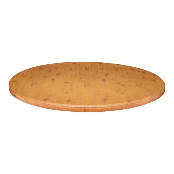 A close-up of a Perfect Tables 24" Outdoor Round Knotty Pine Table Top on a wooden table.