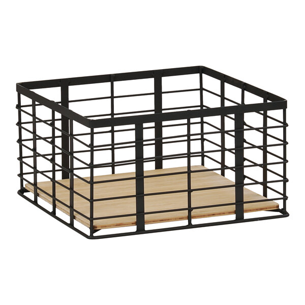 A black metal cage with a wood floor on top.