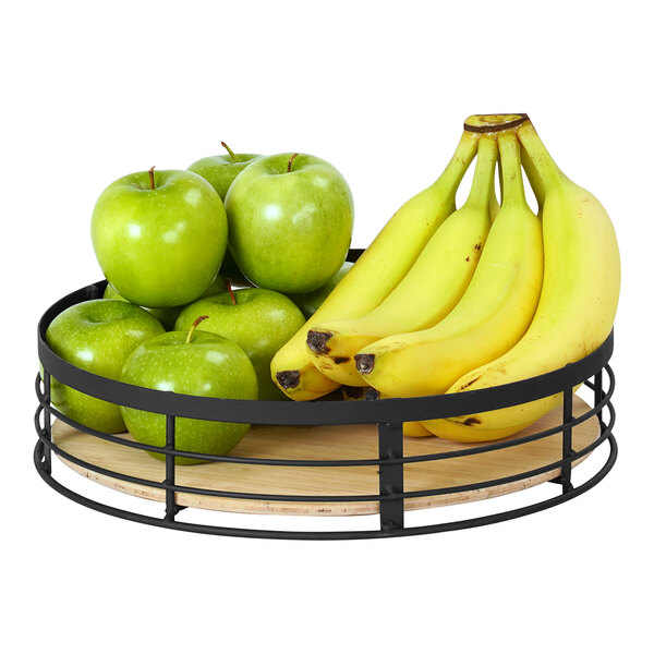 A Cal-Mil Madison black metal and bamboo display riser holding green apples and bananas.