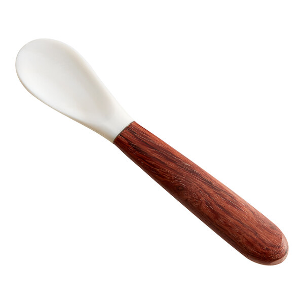 An Acopa Mother of Pearl spoon with a wood handle.