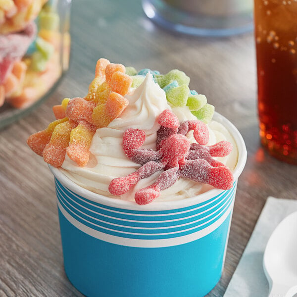 A cup of ice cream with Trolli Sour Brite Gummy Octopus on top.