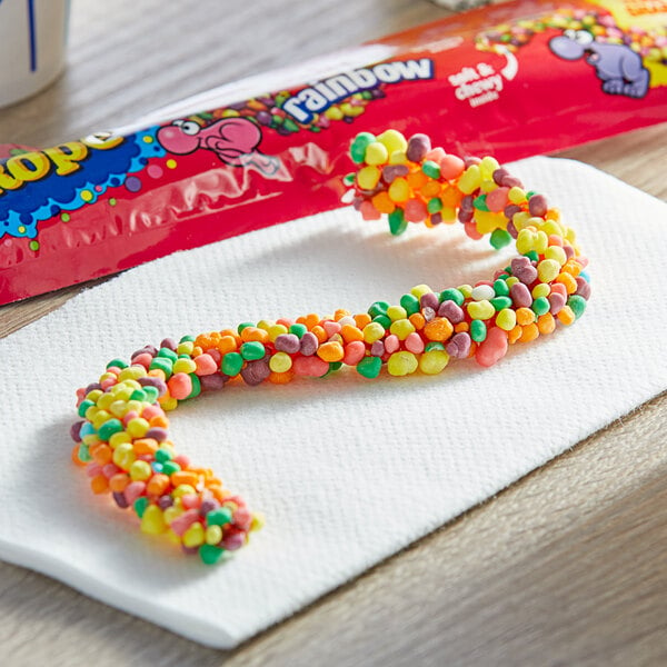 A Nerds rope candy in a red wrapper with a rainbow spiral.